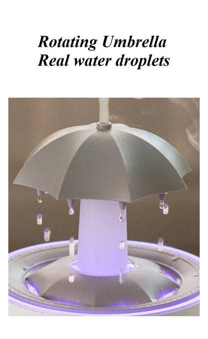 Máquina de aromaterapia con forma de paraguas giratorio y gotas de agua